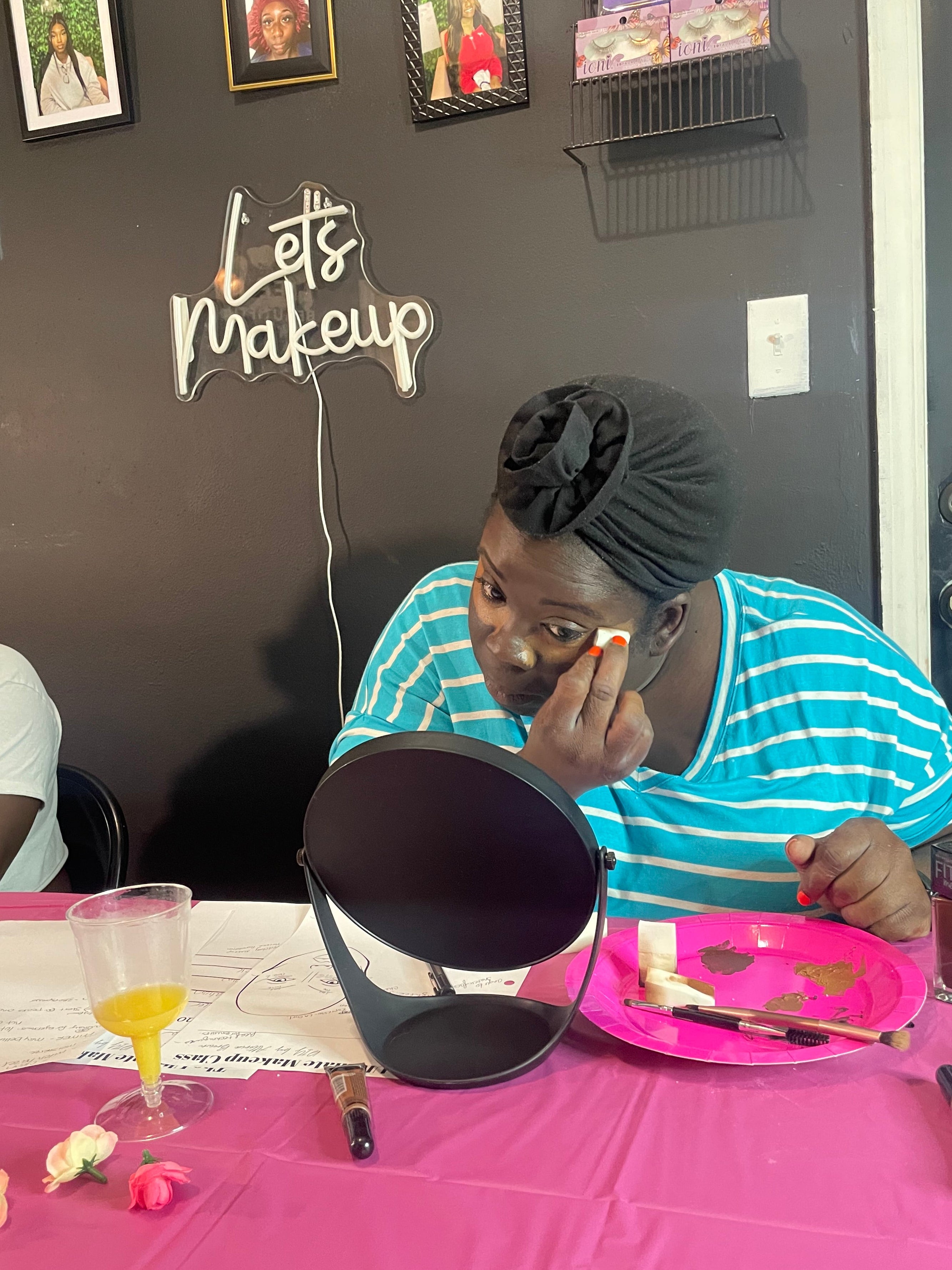 student doing her makeup during  a makeup class taught by altoria brown from WinkLilly beauty